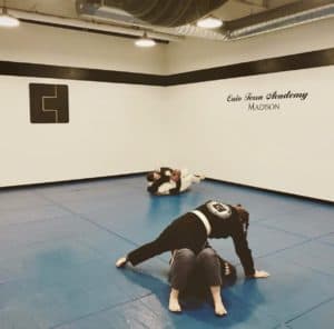 Karen Vieth holding knee on belly in the newly painted Caio Terra Academy Madison, BJJ school.